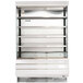 A white refrigerated air curtain merchandiser with glass shelves.