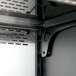 A close up of a metal shelf inside a white Turbo Air refrigerated air curtain merchandiser.