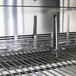 A Turbo Air stainless steel refrigerated prep table with a metal rack.