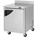 A silver stainless steel Turbo Air worktop freezer with wheels.
