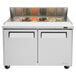 A Turbo Air stainless steel refrigerated sandwich prep table with open doors and food inside.
