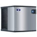 A silver and black Manitowoc Indigo NXT air cooled ice machine with a metal vent.