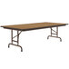 A brown rectangular Correll folding table with a metal frame and wooden top.