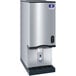 A silver Manitowoc countertop ice maker with a black handle.