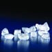 A group of ice cubes from a Manitowoc countertop nugget ice maker on a blue surface.