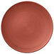 A close-up of a Villeroy & Boch Copper Glow porcelain plate with a spiral pattern in red.