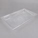 A Carlisle clear plastic food pan with a clear lid on a white surface.