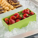 A G.E.T. Enterprises Bugambilia lime resin-coated rectangular salad bowl on a tray of strawberries on ice.