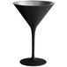 A black martini glass with a silver base and rim on a table.