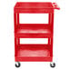 A red plastic utility cart with three shelves and wheels.
