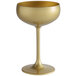 A Stolzle gold coupe wine glass with a white background.