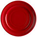 A red Tuxton Concentrix china plate with a spiral pattern.