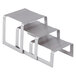 A Vollrath brushed stainless steel 3-piece square buffet riser set with metal bases.