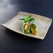 A sandstone rectangular melamine tray with food on it.