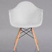 A white Flash Furniture Alonza plastic chair with wooden legs.