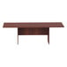 A medium cherry rectangular conference table with legs.