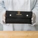 A person holding a black Mercer Culinary Garde Manger case.