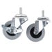 Two Manitowoc swivel casters with rubber wheels and nuts on them.