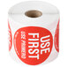 A roll of white National Checking Company Use First labels with red writing.