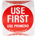 A roll of National Checking Company red and white "Use First" labels with white lettering.