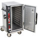 A large metal Metro heated holding cabinet with a door open.