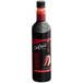 A bottle of DaVinci Gourmet Classic Red Velvet Cake flavoring syrup with dark liquid inside.