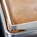 A brown cake in a half-size MFG Tray fiberglass sheet pan with a 2" high pan extender.