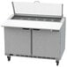 A Beverage-Air stainless steel sandwich prep table with clear lids open over drawers.