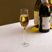 A customizable Arcoroc flute glass of champagne on a table.