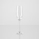 A close up of a clear Arcoroc flute wine glass with a reflection.