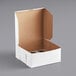 A white cardboard mini cupcake and muffin box with a brown reversible insert.