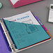 A binder with Avery Big Tab multi-color divider sets with dual pockets.