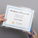 A person using Avery Self-Adhesive Laminating Sheets to laminate a certificate.