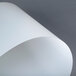 A white translucent paper sheet with curved edges.