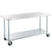 A white metal rectangular work table with black wheels.