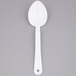 A white plastic spoon with a handle.