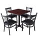 A Lancaster Table & Seating reversible cherry and black table with black chairs around it.