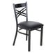 A black metal Lancaster Table & Seating chair with a black cushion.