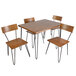 A BFM Seating table with a wood veneer top and 4 wooden chairs with metal legs.