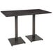 A Lancaster Table & Seating live edge bar height table with a slate gray top and black metal legs.