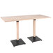 A Lancaster Table & Seating bar height table with a wooden live edge top and black legs.