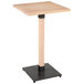 A Lancaster Table & Seating square wooden table with a black metal base.