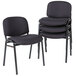 A stack of Alera Continental black fabric stacking chairs.