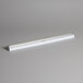 A white tube with a silver strip and a light on it.