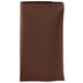 A folded brown Intedge cloth napkin on a white background.