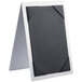 A Menu Solutions Alumitique brushed aluminum rectangular table tent with corner picture corners.