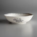 A white porcelain bowl with black floral designs.