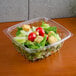 A salad in a Dart rectangular clear plastic container.