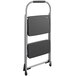 A black and gray Cosco 2 step folding step stool with a metal frame.