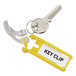 A gray plastic Durable key rack with yellow key clips on it.